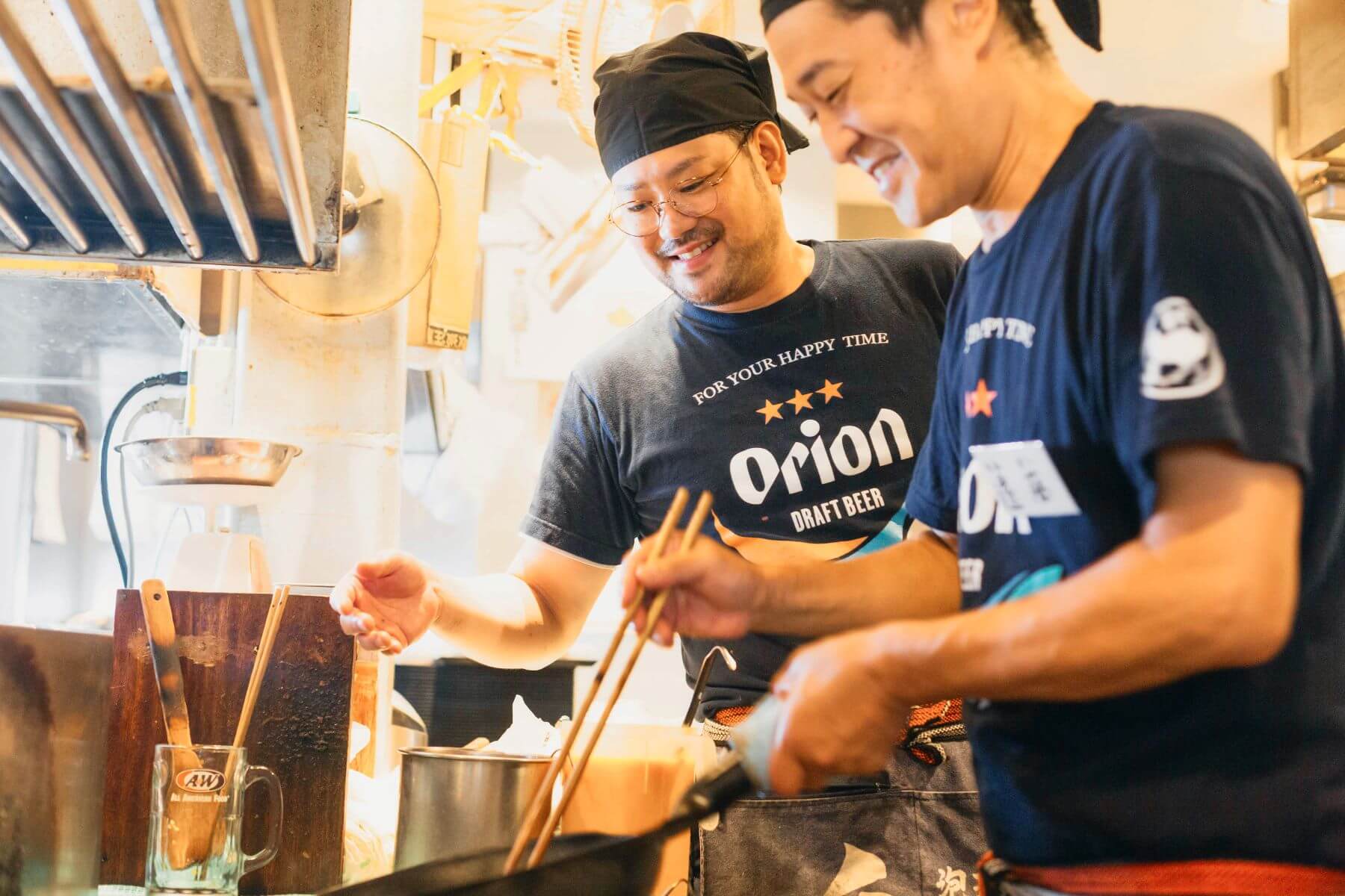 「沖縄食堂 やんばる」の厨房で料理を作るスタッフ